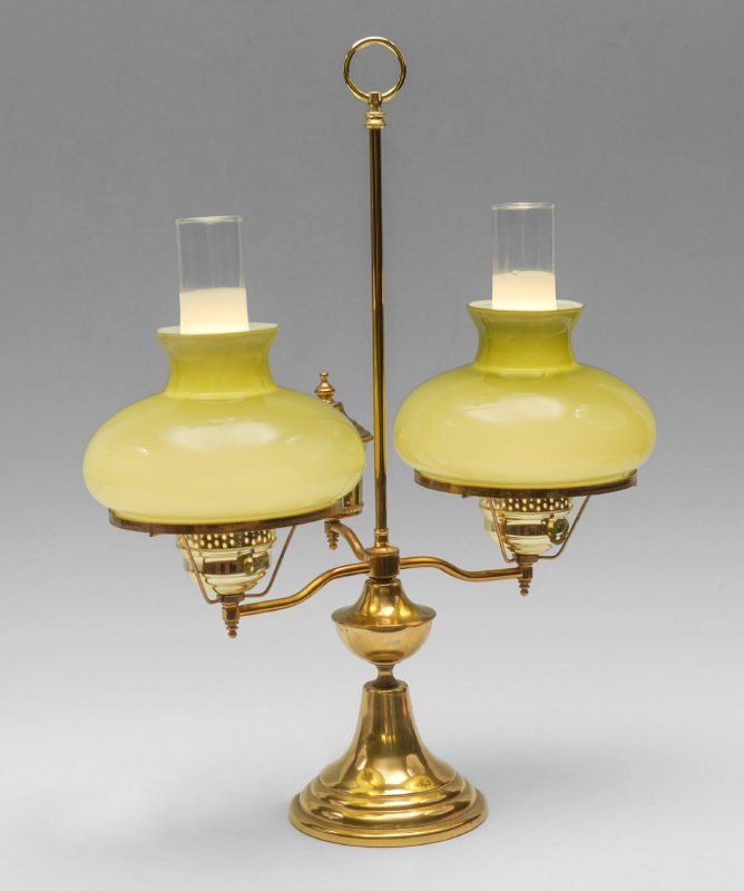 DOUBLE FONT CASED GLASS STUDENT LAMP: DOUBLE FONT CASED GLASS STUDENT LAMP: Brass body double light body with single reserve, electrified, pea green cased glass shades. Body measures 25" h. x 17 1/2" x 9 3/4". Shades measure 5 3/4" h. x 8