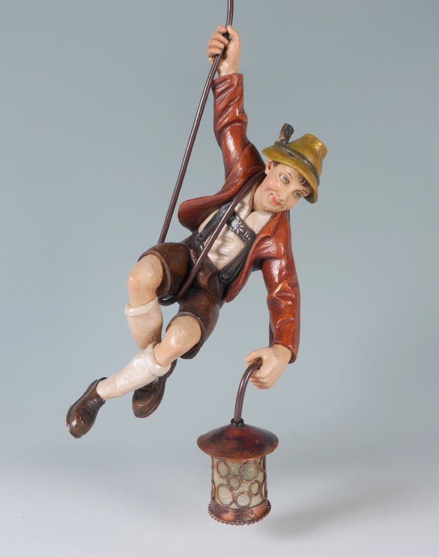 WHIMSICAL BLACK FOREST MOUNTAIN CLIMBER LAMP: A WHIMSICAL FIGURAL BLACK FOREST MOUNTAIN CLIMBER LAMP: Polychrome decorated carved wood figure of a Alpine mountain climber holding a small lamp with single light, hanging from the electrical cord. O