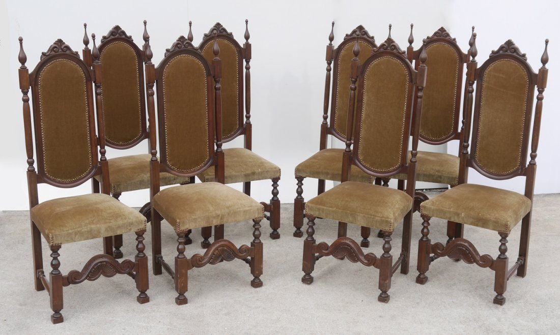 SET OF 8 HIGH BACK GOTHIC WALNUT DINING CHAIRS: SET OF 8 HIGH BACK WALNUT DINING CHAIRS: Gothic style side chairs, carved crest over oval back, spire finial atop turned supports. Turned front legs, shell carved stretcher, velvet upholstery. Measure