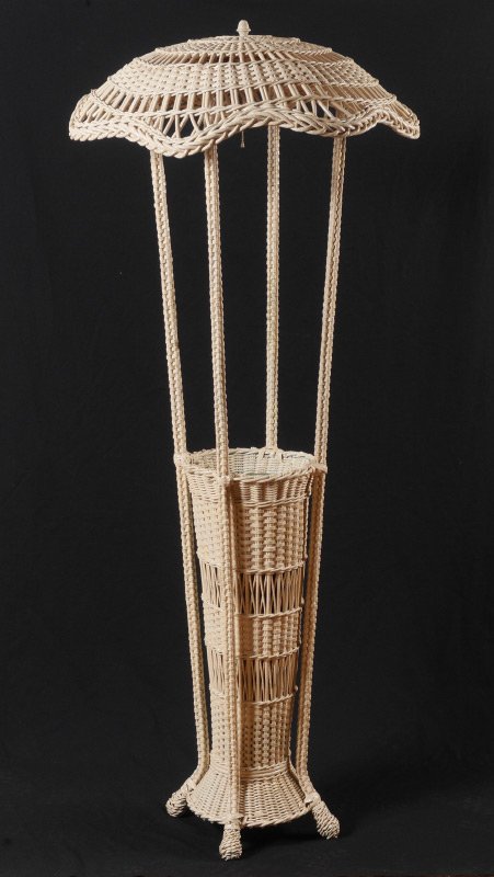 WICKER FLOOR LAMP & UMBRELLA STAND: WICKER FLOOR LAMP & UMBRELLA STAND: Parasol style top with 4 triple fixture socket, 4 supports, base with metal insert for umbrellas & canes, on 4 feet. Overall measures 70" h. x 29 1/2" dia.