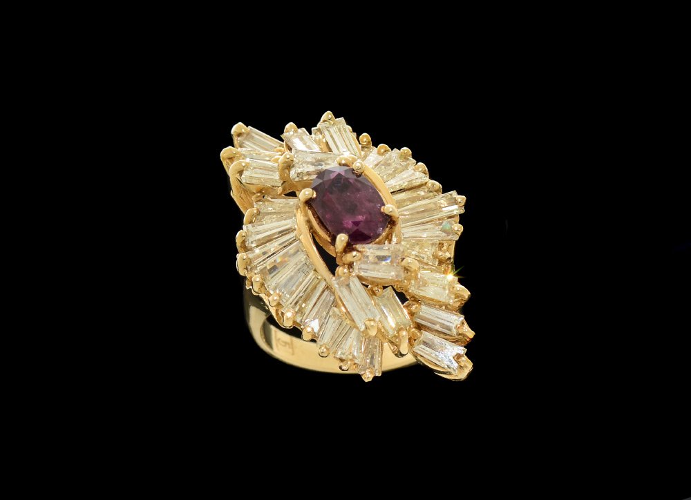 1.20 CT RUBY RING W/ 5 CTW DIAMOND BAGUETTES 14K: SOLITAIRE RUBY AND DIAMOND BAGUETTES RING: An oval ruby of 1.2 Ct. and SI clarity (Type II) is the centerpiece of this 14K yellow gold ring. It is surrounded by 34 baguette cut diamonds totaling appro