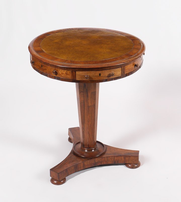 ROUND BIEDERMEIER OCCASIONAL TABLE: ROUND BIEDERMEIER OCCASIONAL TABLE: Round top with replacement inset leather surface, skirt with 3 drawers, tapered octagonal support, flared tri-foot base. Overall measures 28 3/4" h. x 24 1/2". Sold