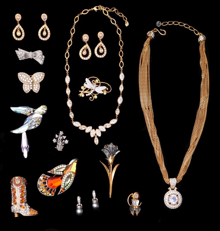 14 PIECE SWAROVSKI JEWELRY: COLLECTION OF SWAROVSKI JEWELRY: 14 piece group of figural brooches to include large birds, cowboy boot, butterflies, and flowers, a pendant necklace, a crystal necklace, and 3 pairs of earrings. Sign