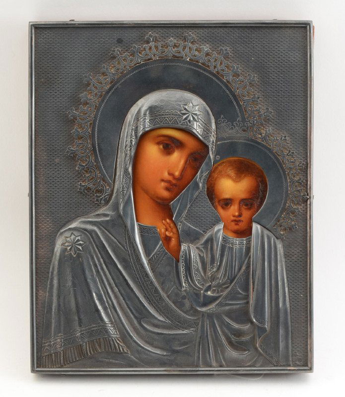 ICON OF MADONNA AND INFANT JESUS GRACHEV OKLAD: ICON OF MADONNA AND INFANT JESUS GRACHEV OKLAD: Elaborate Russian Icon with Silverwork by Grachev. Painting is on Tin affixed t Wood, 8 5/8" x 7". The Oklad is marked on 3 separate pieces with the imp