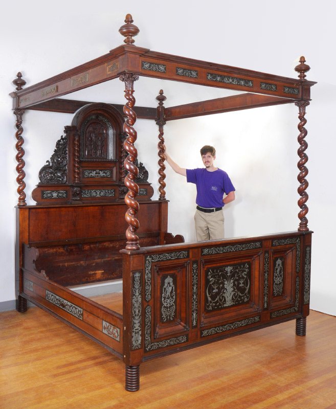 A FINE GERMAN CARVED & INLAID 4 POSTER BED: A FINE GERMAN CARVED & INLAID 4 POSTER BED: As seen in the 1941 movie "Blood & Sand" starring Tyrone Power and Rita Hayworth. Extravagantly carved headboard with arched center panel with angel and rel
