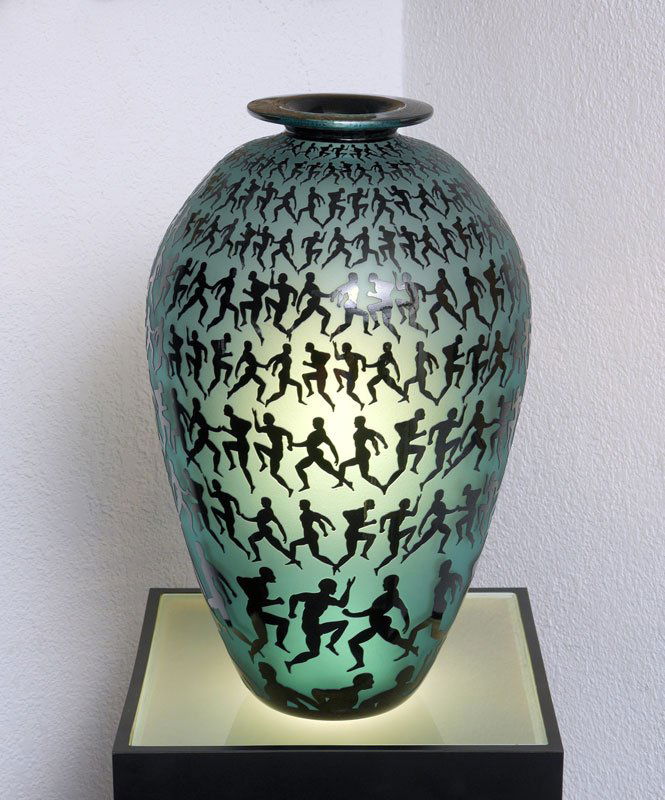 DUNCAN MCCLELLAN METAMORPHASIS ART GLASS VASE: MCCLELLAN, Duncan, (American, 1955-): "Metamorphosis", Blue glass vase with graduating bands of running figures. Original exhibition label / price tag taped to base, no visible signature. Measures 18