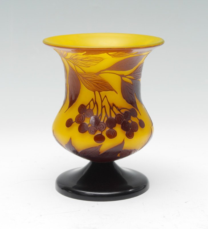 LOETZ YELLOW CAMEO GLASS VASE: LOETZ YELLOW CAMEO GLASS VASE: Unsigned attribution to Loetz, foliate and berry design on yellow ground, black glass foot. 6 3/4'' h. x 5 1/4''.