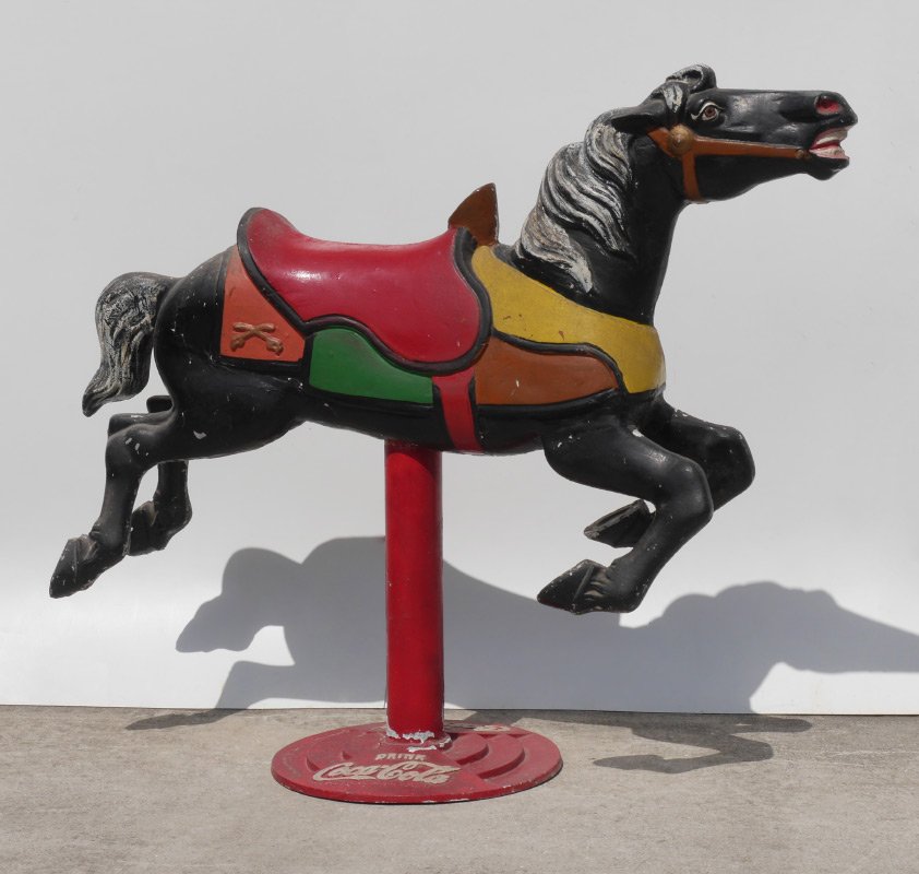 COCA COLA CAST METAL CAROUSEL HORSE: COCA COLA CAST METAL CAROUSEL HORSE: Circa 1950's, polychrome paint decorated carousel style horse with embossed Coca-Cola emblem on base. Overall measures 48 1/2" x 57" x 20".