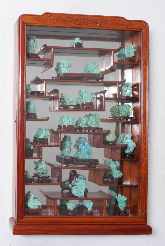 CARVED ORIENTAL CABINET WITH TURQUOISE CARVINGS: CARVED ORIENTAL CABINET WITH TURQUOISE CARVINGS: Carved oriental motif wall hanging display cabinet and contents, approx. 26 assorted carved turquoise, dyed stone and composite figurines, most with st