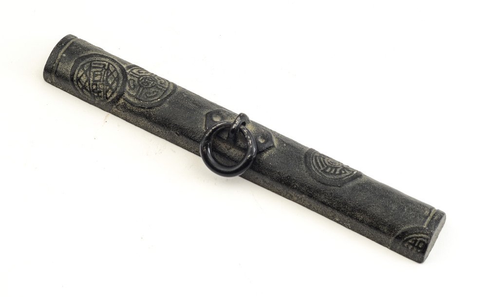 CHINESE IRON SCROLL WEIGHT: CHINESE IRON SCROLL WEIGHT: Black iron with embossed symobolic design, ring handle to top, 8"l. x 1"w. Perfect weight for previous lot 1405A.