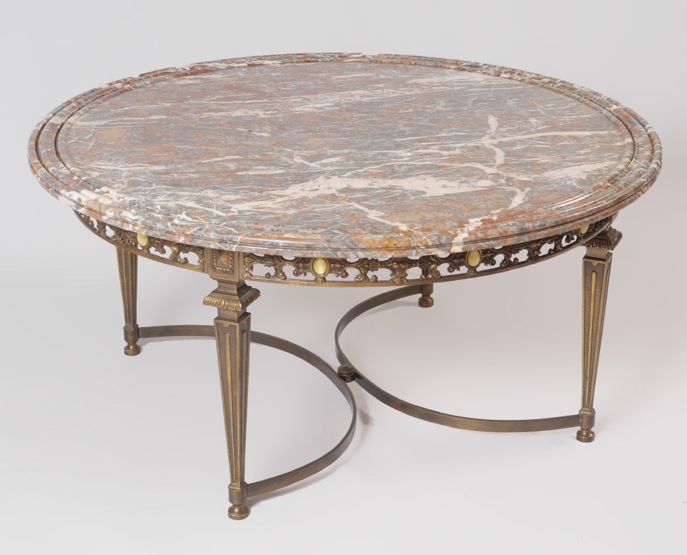 MARBLE TOP COFFEE TABLE WITH METAL BASE: MARBLE TOP COFFEE TABLE WITH METAL BASE: Round marble top with grooved edge. Cast metal base, open work apron with applied cabochons, tapered legs, semi circle stretchers. Overall measures 19'' h. x 3