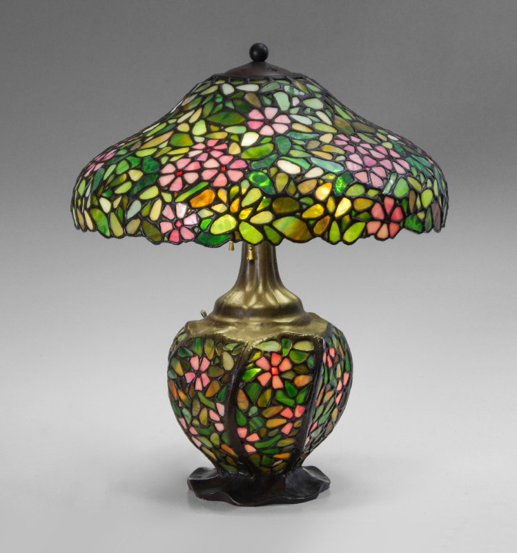 PEONY PATTERN LEADED GLASS TABLE LAMP: PEONY PATTERN LEADED GLASS TABLE LAMP: Handel mark to heat ring, we believe this to be a nicely executed replication. Leaded glass base and shade, 3 socket fixture, base 23" h. x 9 1/2", shade 7 1/2" 