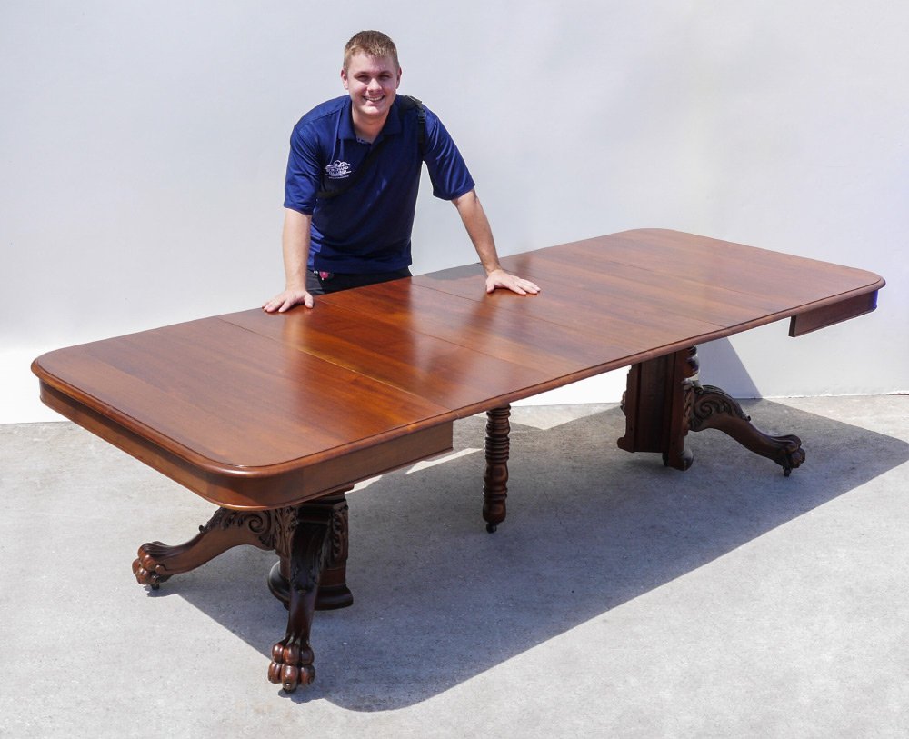 MAHOGANY BALL AND CLAW FOOT BANQUET DINING TABLE: MAHOGANY BALL AND CLAW FOOT BANQUET DINING TABLE: Rectangular top, pedestal base with splayed legs ending in claw feet, turned center support revealed when top expanded to accommodate the four 15" lea