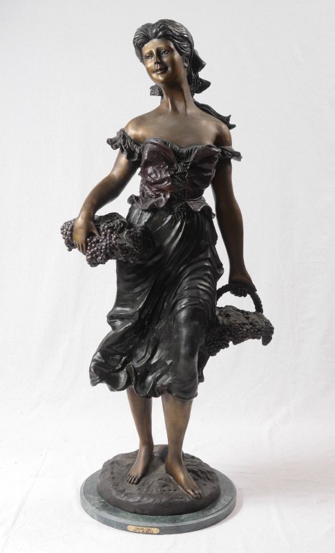 AFTER HYPOLITE MOREAU GRAPE GIRL BRONZE: AFTER HYPOLITE MOREAU "GRAPE GIRL" BRONZE: Bronze figure of a maiden holding a basket of grapes, signed on base "H. P. Moreau by Castano" and dated '89. Affixed to marble base with brass plaque. Overa