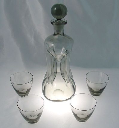 HOLMEGAARD DANISH ART GLASS DECANTER AND CORDIALS: HOLMEGAARD DANISH ART GLASS DECANTER AND CORDIALS: Smokey in color, the decanter with ball stopper is 11 1/2"h, the cordials are 2 1/2"h.