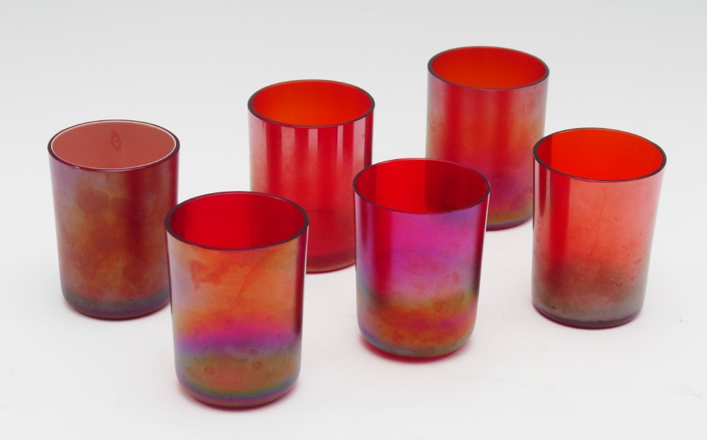 6 STEUBEN RED AURENE TUMBLERS: 6 STEUBEN RED AURENE TUMBLERS: Marked Steuben inside base, iridescent red, one tumbler cased on inside, each measures 3 1/2" h. x 2 3/4".