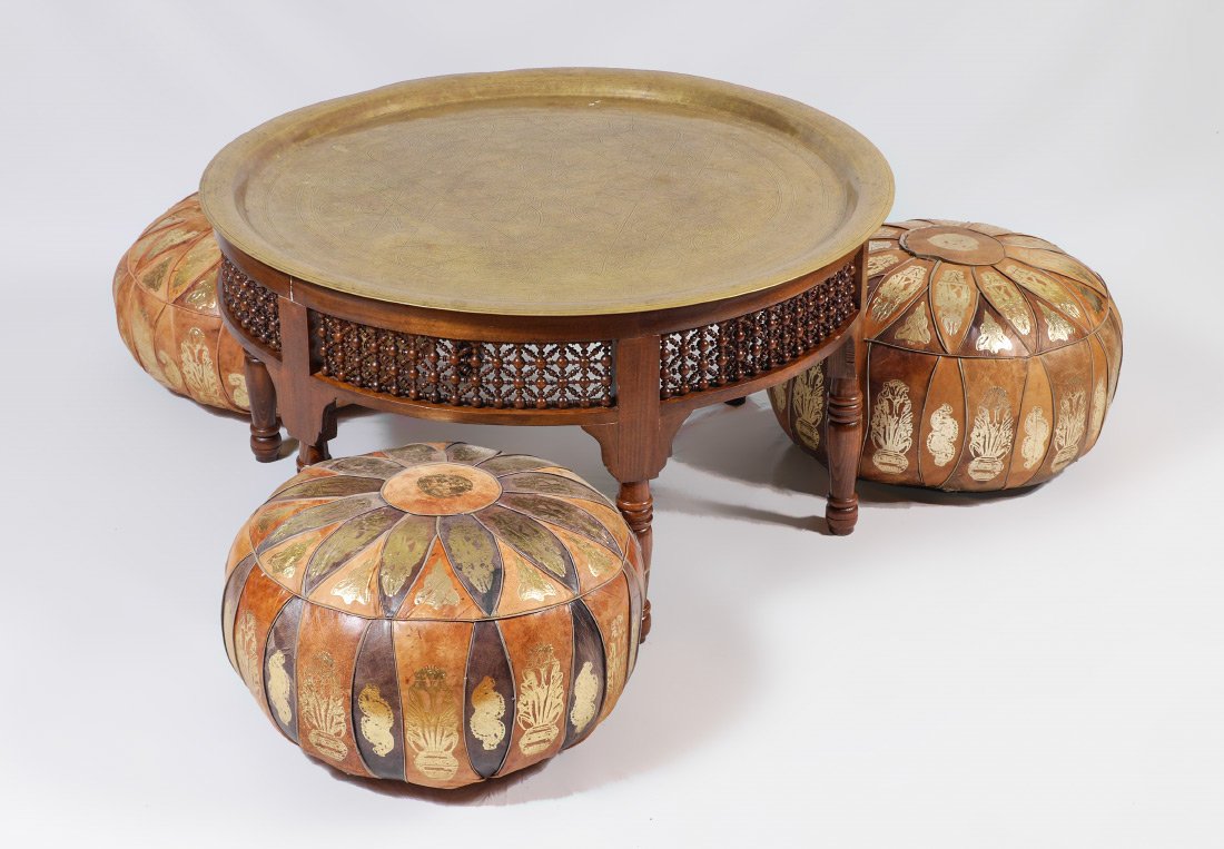 MIDDLE EASTERN BRASS TRAY TOP TABLE: MIDDLE EASTERN BRASS TRAY TOP TABLE: Middle eastern style engraved round removable brass tray top, wood base with openwork panels, turned legs. Overall measures 20" h. x 39". Sold with 3 gilt embossed