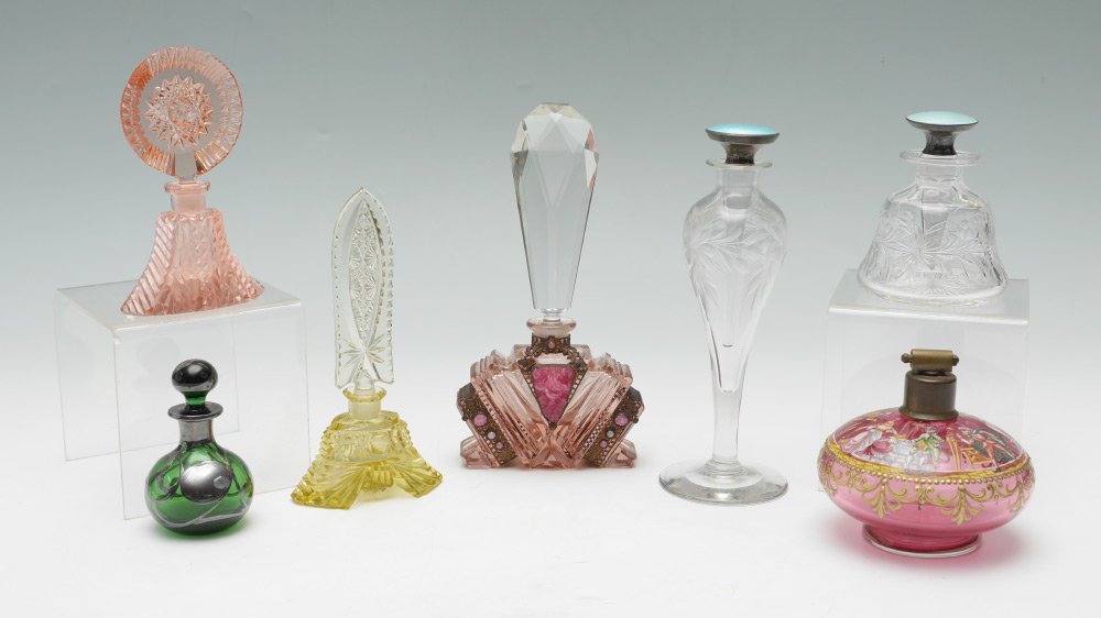 ESTATE COLLECTION OF 7 GLASS PERFUMES: ESTATE COLLECTION OF 7 GLASS PERFUMES: An assembled collection of 7 perfume bottles to include 1) Sterling overlay green glass with stopper, 3 1/2'' h. 2) Czech amber cut glass with tall stopper, 6 1/