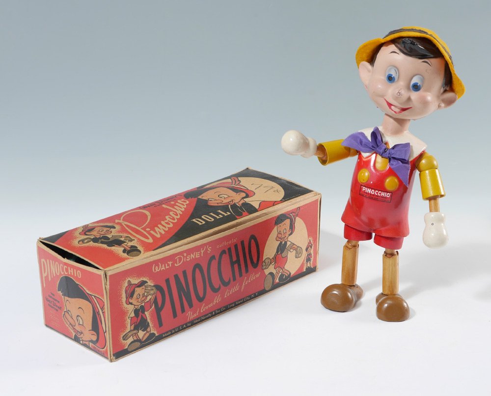 IDEAL WOOD JOINTED PINOCCHIO DOLL IN BOX: IDEAL WOOD JOINTED PINOCCHIO DOLL IN BOX: Composition head, painted body with Pinocchio sticker on chest, jointed arms, legs and head. Purple bow, felt hat with feather, original Ideal Novelty & Toy C