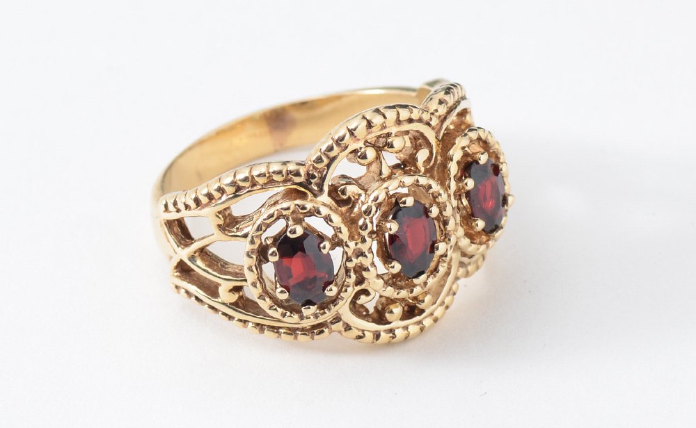 3 STONE GARNET RING SIZE 9: THREE STONE GARNET RING: Etruscan style 14K yellow gold ring with 3 oval faceted garnets totaling approx. 3 Ct. Size 9. Weight 8 grams.
