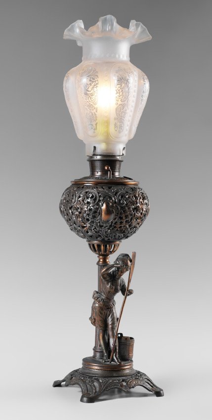 BRADLEY & HUBBARD FIGURAL BANQUET LAMP: BRADLEY & HUBBARD FIGURAL BANQUET LAMP: Patinated cast iron base, figural stem with woman in shorts holding an oar with a bucket behind her, patinated floral motif reservoir cover. Marked B & H on res