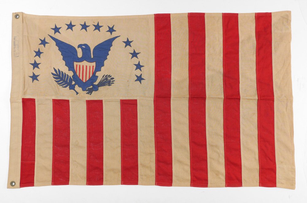 US RESERVE CUTTER COTTON FLAG: US RESERVE CUTTER COTTON FLAG: Early to mid 20th century, cotton flag, canton with eagle and shield under 13 stars, field with 16 red and white stripes. Stamped Bulldog on header, overall measures 30"