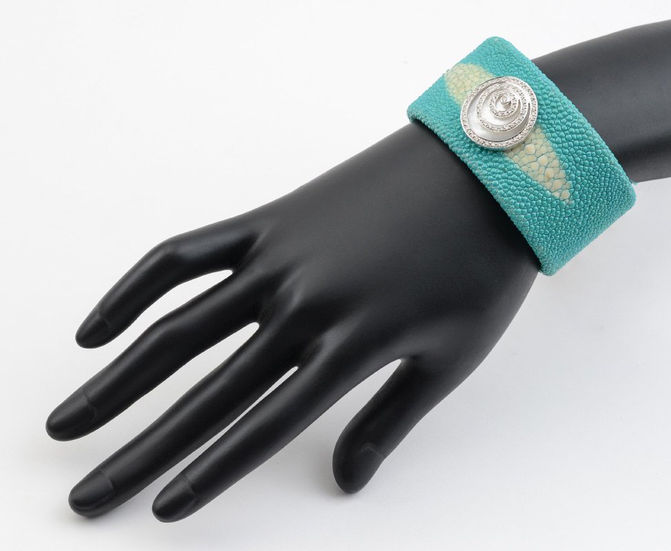SHAGREEN SLTINGRAY CUFF BRACELET: TURQUOISE SHAGREEN STINGRAY LEATHER CUFF BRACELET: Mother of pearl and diamond medallion stamped 18K. Width 1.25".