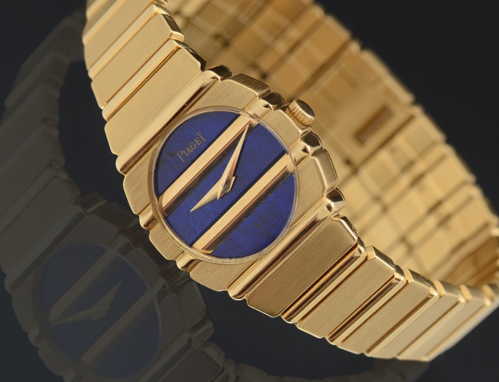 18K PIAGET LADIES WATCH: PIAGET 18K GOLD LADIES WRISTWATCH: 18K yellow gold watch and band. The dial is cobalt blue, possibly lapis. The integrated bracelet is comprised of alternating polished and mat links. Quartz movement.