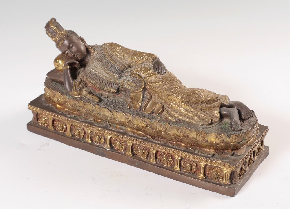GILT BRONZE FIGURE OF RECLINING BODHISATTVA: GILT BRONZE FIGURE OF RECLINING BODHISATTVA: Bronze figure with gilt accents, reclining or sleeping bodhisattva on lotus blossom, base with columns and floral motif. No visible signature or markings. 