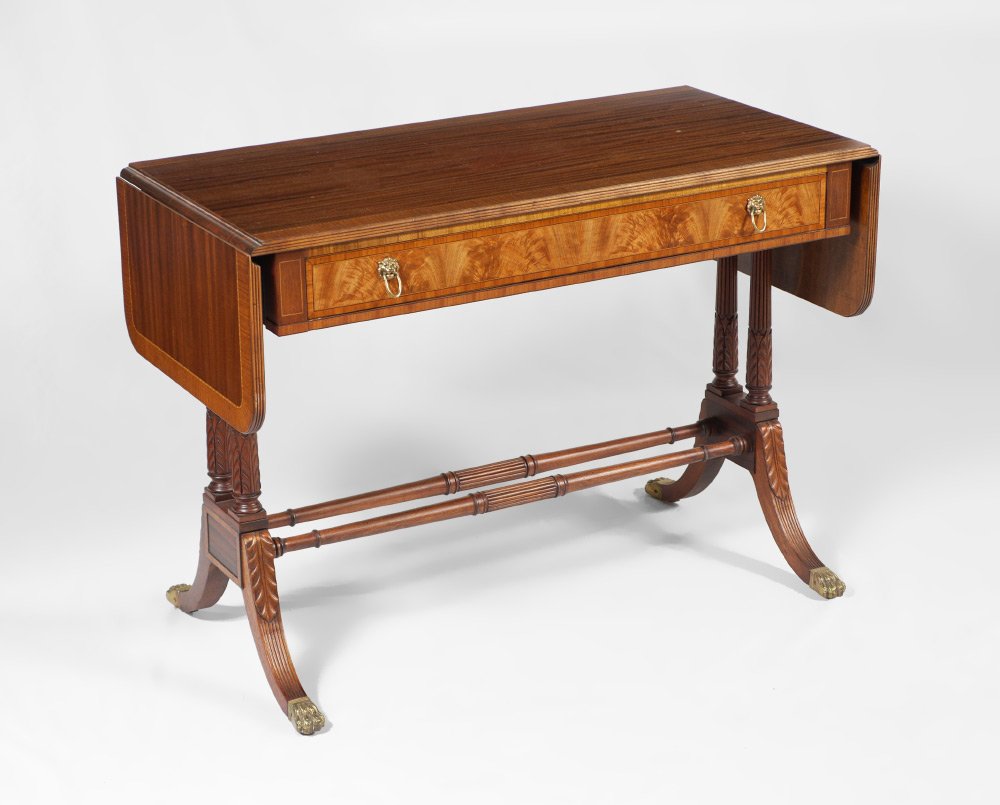 DROP LEAF MAHOGANY WRITING TABLE: DROP LEAF MAHOGANY WRITING TABLE: Banded mahogany with string inlay, fluted trim, single drawer with tag from The Morton-Hales Company Cincinnati, lion masqueron pulls, turned stretchers and supports,
