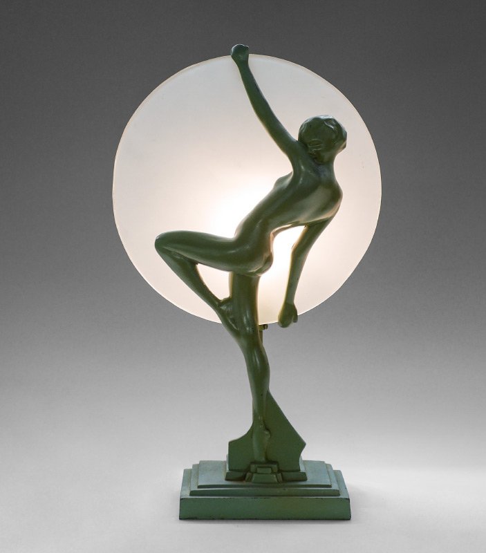 FRANKART ART DECO FIGURAL SILHOUETTE LAMP: FRANKART ART DECO FIGURAL SILHOUETTE LAMP: Green painted cast metal figure of a nude dancing maiden holding a frosted glass shade, marked Frankart Inc. and Pat. Appld For. Stepped base, overall measur