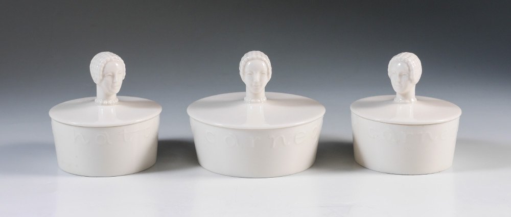 3 HATTIE CARNEGIE DRESSER BOXES FOR LENOX: HATTIE CARNEGIE DRESSER BOXES FOR LENOX: Circa 1940, 3 porcelain lidded dresser boxes, powder or trinket boxes with woman's head finials to the tops, embossed Hattie Carnegie around the edge of each b