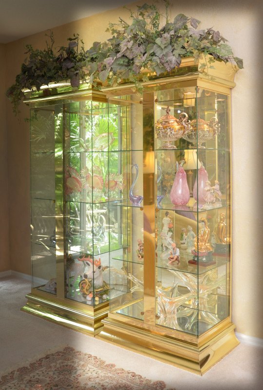 MASTERCRAFT BRASS GLASS DISPLAY CABINET: MASTERCRAFT BRASS GLASS DISPLAY CABINET: Polished brass trim and center support, 2 glass doors, glass shelves, illuminated mirrored back interior. Overall measures 82 1/4" x 38" x 22 1/4". For a pair