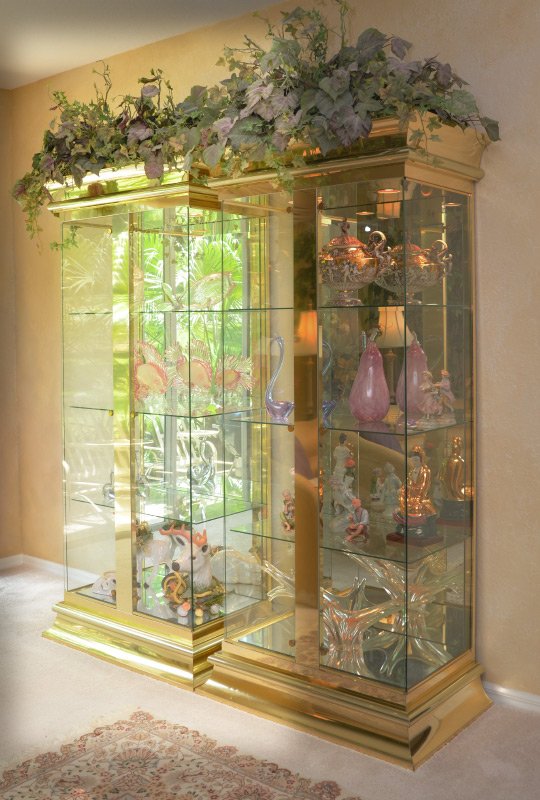 MASTERCRAFT BRASS GLASS DISPLAY CABINET: MASTERCRAFT BRASS GLASS DISPLAY CABINET: Polished brass trim and center support, 2 glass doors, glass shelves, illuminated mirrored back interior. Overall measures 82 1/4" x 38" x 22 1/4". For a pair