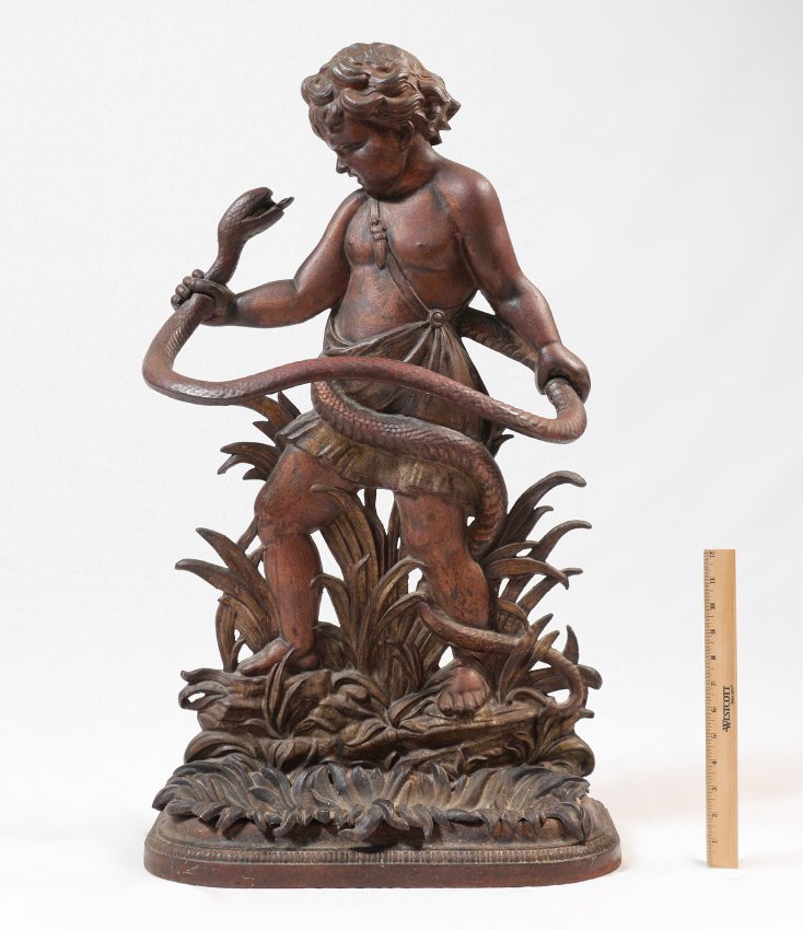 COALBROOKDALE HERCULES CAST IRON UMBRELLA STAND: COALBROOKDALE HERCULES & THE SNAKE CAST IRON UMBRELLA STAND: Allegorical figural cast iron umbrella stand with figural of the child Hercules fighting a snake, traces of red paint remain, lower cast ir