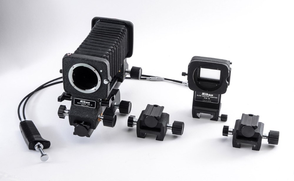 NIKON PB-6 BELLOWS W/ PS-6 SLIDE ADAPTER: NIKON PB-6 BELLOWS W/ PS-6 SLIDE COPYING ADAPTER: Used in conjunction typically with a 50mm macro lens, the bellows are excellent for critical macro work. Also includes two PBS-6 sliders and a remote