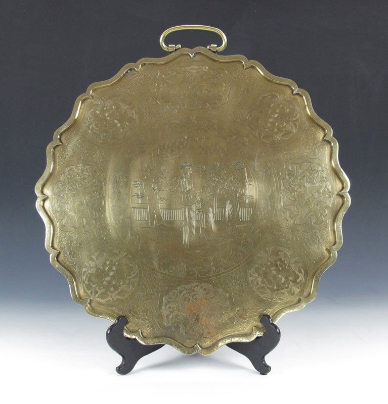 LARGE BRASS ORIENTAL MOTIF CHARGER WALL HANGING: LARGE BRASS ORIENTAL MOTIF CHARGER: Heavy brass with engraved decorations of figures, flowers, bamboo, and other oriental motifs. Single handle. 22'' dia. overall.