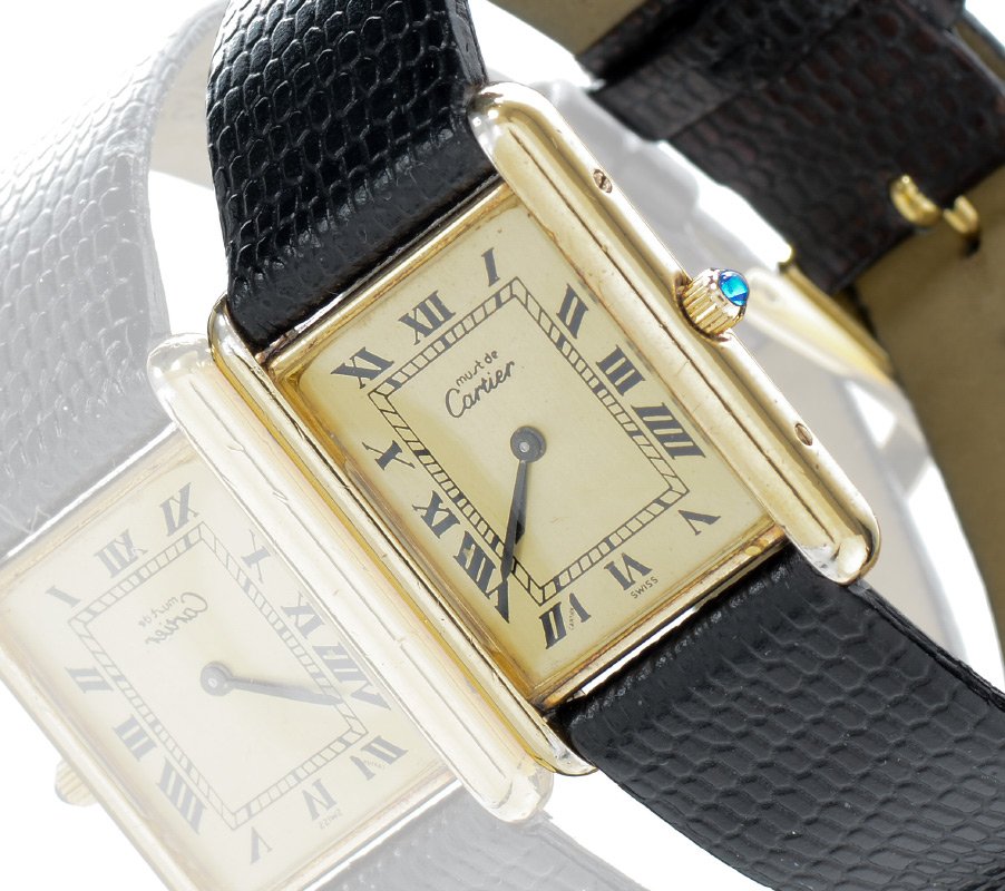 CARTIER MUST DE TANK UNISEX WATCH: CARTIER MUST DE TANK UNISEX WATCH: Swiss made quartz movement. 20 micron 18kt yellow gold electroplated over .925 sterling silver case.. Champagne color dial with classic Cartier Roman black printing.