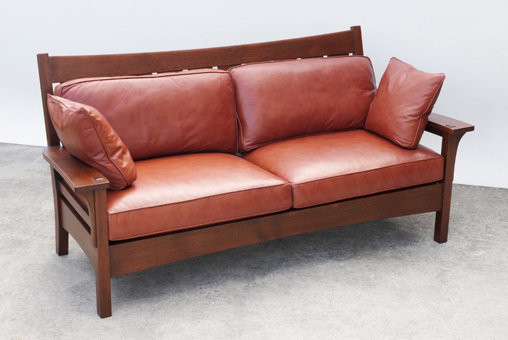 CONTEMPORARY STICKLEY FURNITURE SETTLE: CONTEMPORARY STICKLEY FURNITURE SETTLE: 21st century production, oak frame stamped Stickley under front skirt, brown leather upholstery and throw pillows. Measures 39 3/4" h. x 83 1/4" x 36".