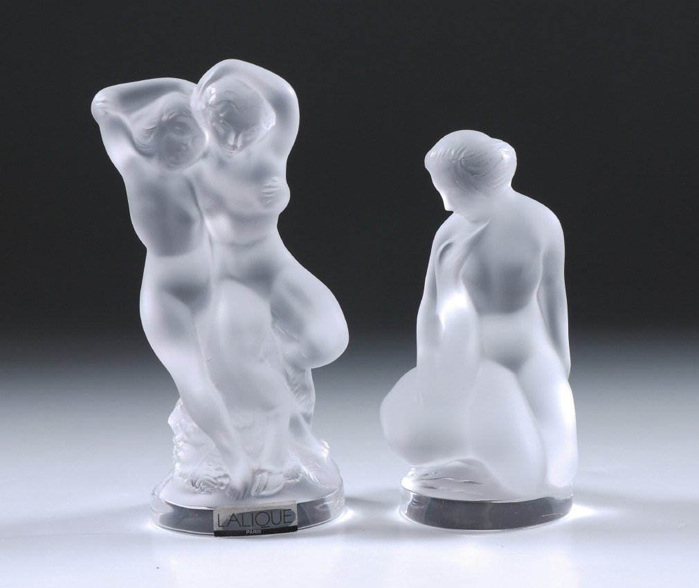 2 LALIQUE CRYSTAL NUDE PAPERWEIGHTS: 2 LALIQUE CRYSTAL NUDE PAPERWEIGHTS: 2 pieces total to include 1) "Faune" man and woman, 5 1/2" h., original box. 2) Kneeling nude with swan, 4 3/4" h., original box, 2 3/4" h. x 7" x 4".