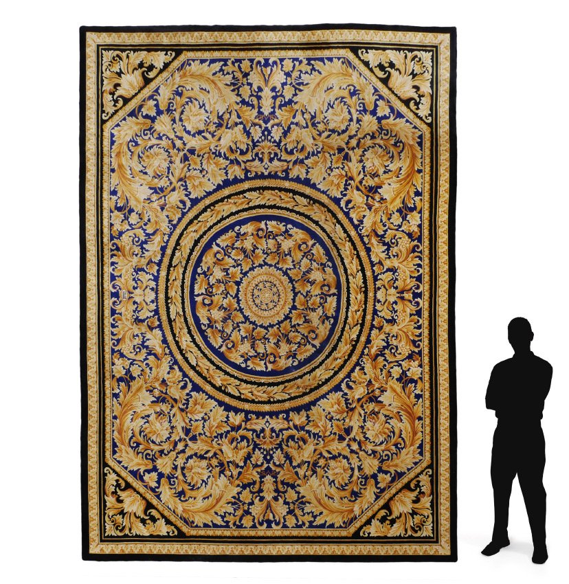 GIANNI VERSACE HOME SIGNATURE CARPET 9'9" x 13': GIANNI VERSACE HOME SIGNATURE CARPET, 9'9" x 13': Hand knotted carpet with vibrant blue and black ground. Center medallion of blue with golden rings of flowers and leaves, the largest band is grape vi