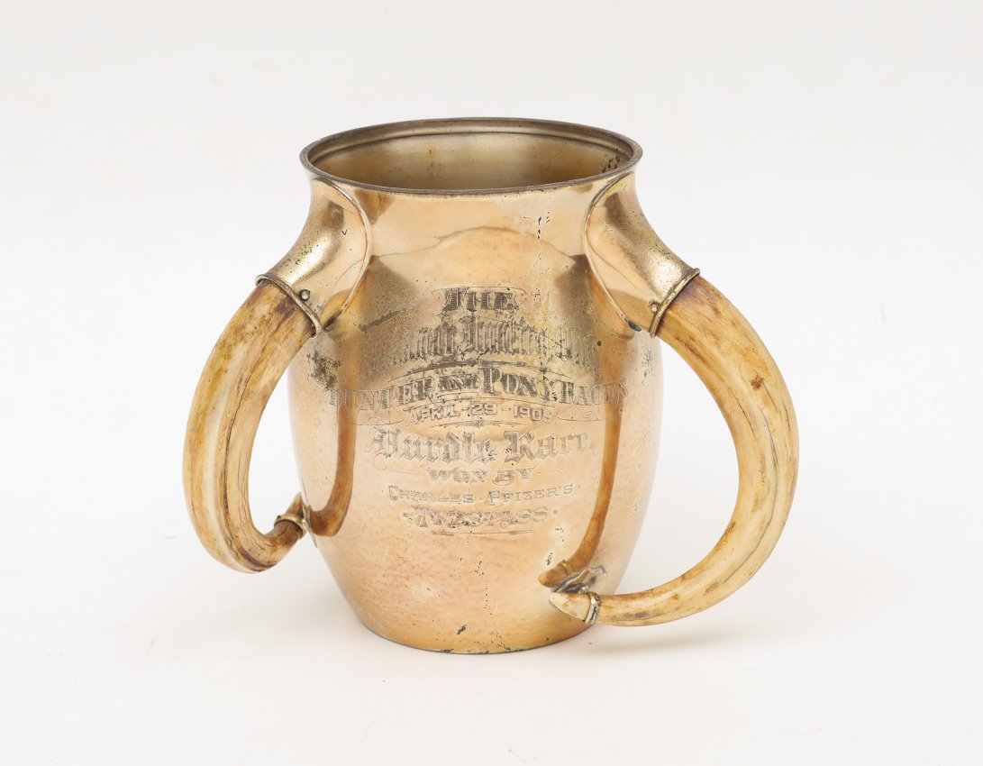 ROCKAWAY HUNTING CLUB STERLING PRESENTATION TROPHY: ROCKAWAY HUNTING CLUB STERLING PRESENTATION TROPHY: 1905 Meriden Brittania Co. presentation trophy with 3 mounted boar tusk handles, vermeil gold plated finish. Presentation reads "The Rockaway Hunt C