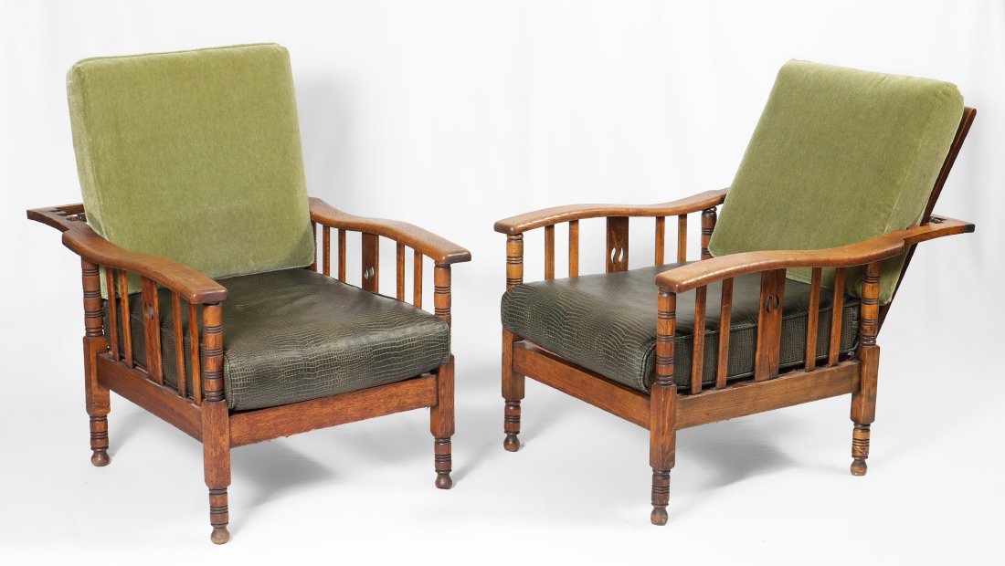 PAIR OF TRANSITIONAL OAK MORRIS CHAIRS: PAIR OF TRANSITIONAL OAK MORRIS CHAIRS: Oak frame with 3 reclining positions, shaped arms, center side splat with pierced decoration, turned legs. Green faux alligator seat, green upholstered cushion.