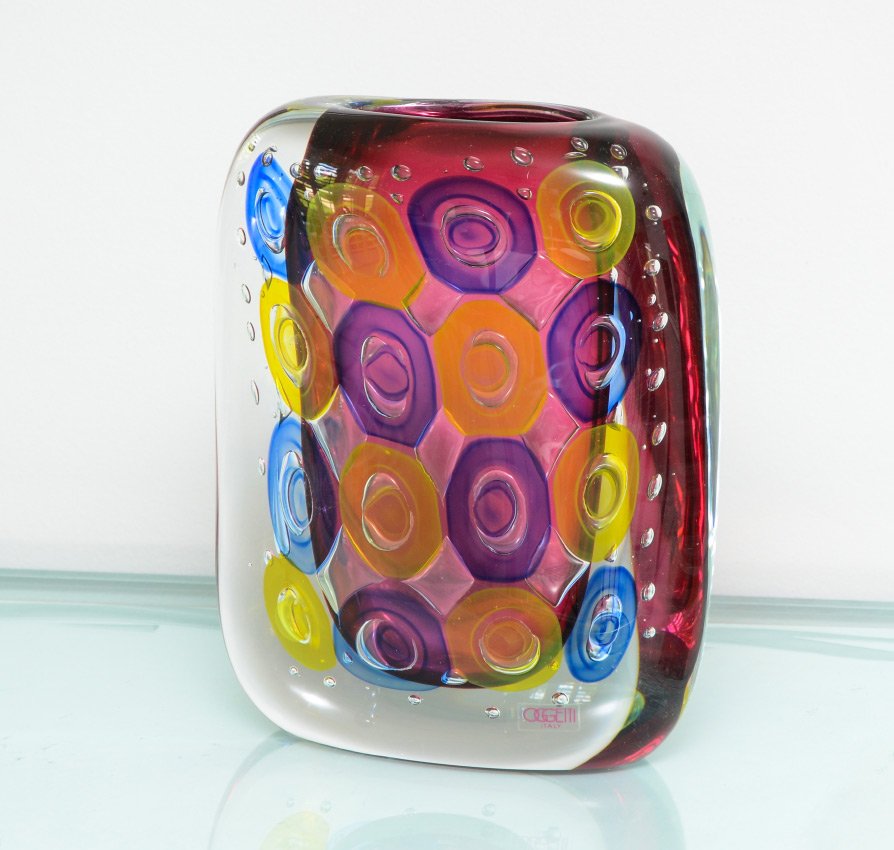 LUIGI ONESTO FOR OGGETTI MURANO GLASS VASE: LUIGI ONESTO FOR OGGETTI MURANO GLASS VASE: Multi color design with control bubble, signed L. Onesto, Murano, Italy with original Oggetti clear label. Overall measures 10 3/4'' h. x 8 1/4'' x 4''.