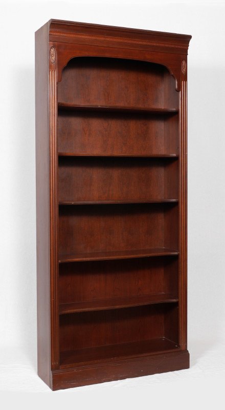 CONTEMPORARY ETHAN ALLEN BOOKCASE: CONTEMPORARY ETHAN ALLEN BOOKCASE: Mahogany finish, carved floral medallions over fluted stiles, 5 serpentine shelves. Overall measures 78 1/2'' h. x 34 1/4'' x 12 1/4''.