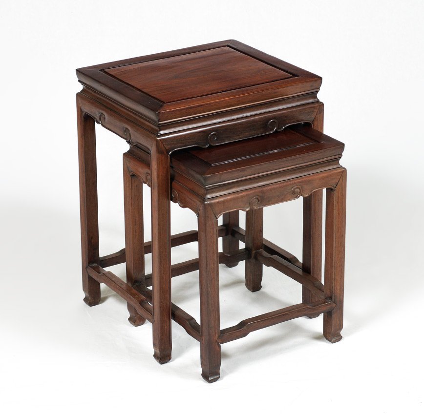 PAIR CHINESE ROSEWOOD NESTING TABLES: PAIR CHINESE ROSEWOOD NESTING TABLES: Rectangular tops, carved skirt, shaped stretchers. Larger measures 19 3/4'' h. x 14 1/2'' x 12 1/2''.