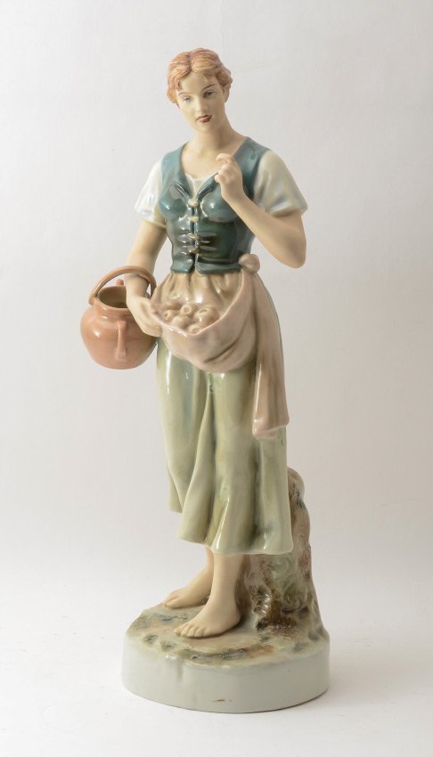 ROYAL DUX FIGURINE OF A APPLE PICKER: ROYAL DUX FIGURINE OF AN APPLE PICKER: Figure of a maiden holding apples in her smock, and a pitcher on her arm. Well marked inside base, overall measures 20 1/2" h. x 8".