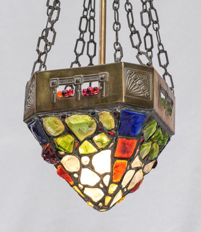 AUSTRIAN JEWELED CHUNK GLASS HANGING LIGHT: AUSTRIAN JEWELED CHUNK GLASS HANGING LIGHT: Downward pyramid shade with inset chunk glass in a variety of colors, brass top of shade with embossed designs at canted corners. Long single down rod and f