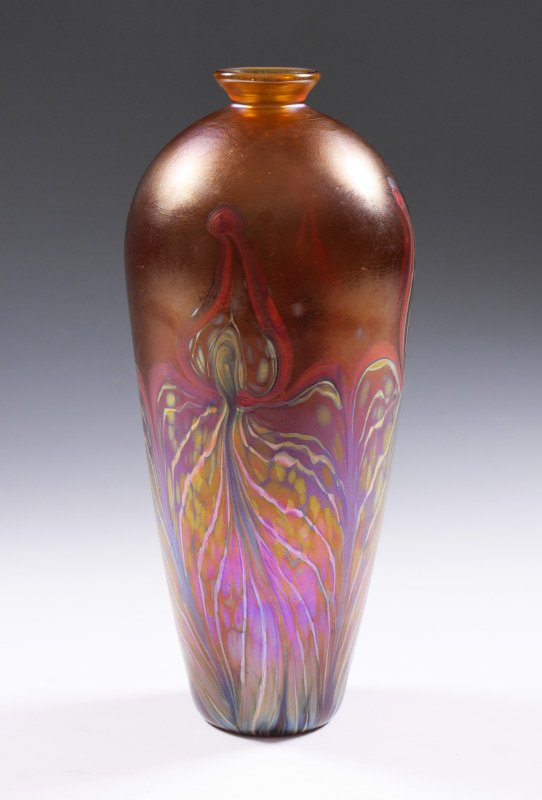 ANDY PAIKO ART GLASS VASE: PAIKO, Andy, (American, Contemporary): Elongated vase with narrow neck and rim, iridescent amber ground, stylized floral pulled feather design. Signed on base Andy Paiko, Phoenix, '99. Overall measure