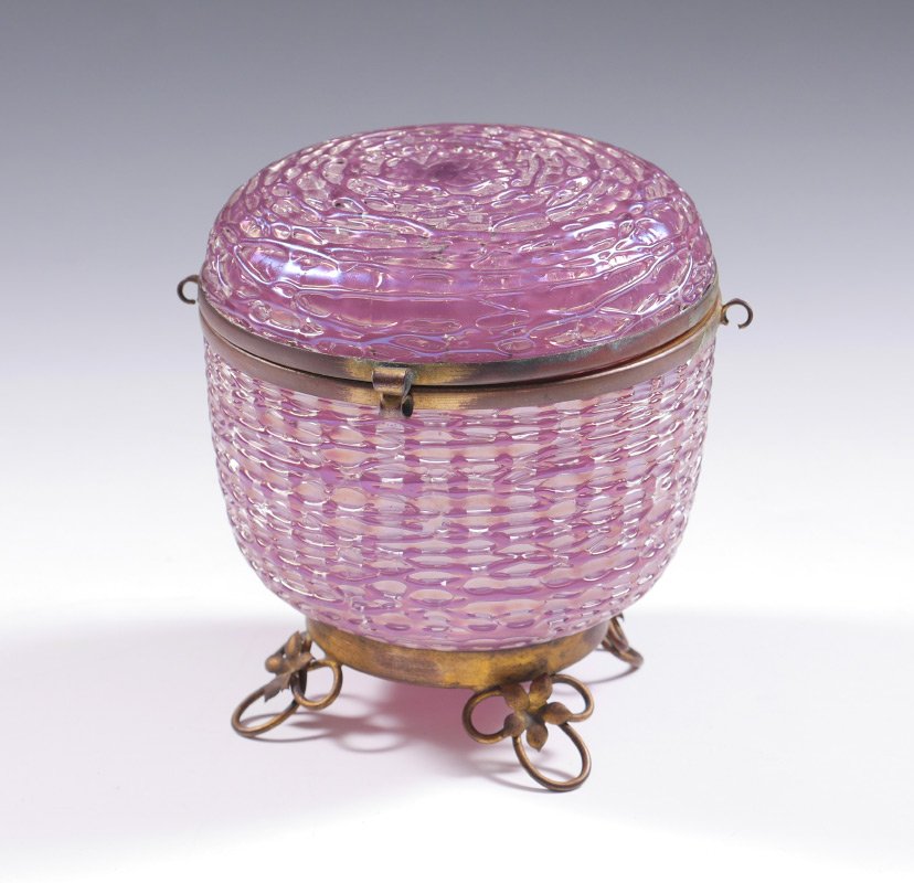 LOETZ PINK CHINE MOUNTED LIDDED JAR: LOETZ PINK CHINE MOUNTED LIDDED JAR: Iridescent Pink Chine decorated covered jar with brass rim and mounted feet. Unmarked attribution, overall measures 5" h. x 5".